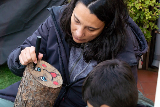 Decorating a Tio de Nadal for Catalonian Tradition