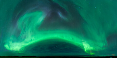 Aurora borealis illuminating night sky in vibrant green hues