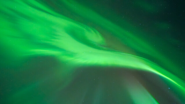 Panorama of vibrant green aurora borealis display