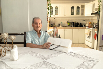 Latino senior citizen with a white shopping bag