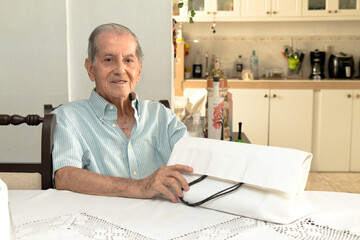 Latino senior citizen with a white shopping bag