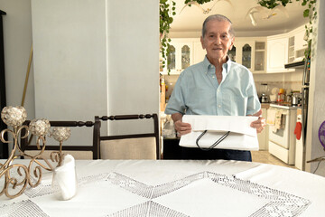Latino senior citizen with a white shopping bag