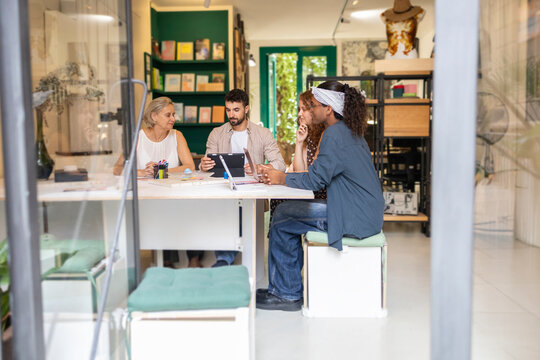Collaborative team discussion in a modern coworking space - Powered by Adobe