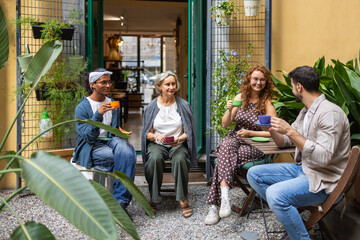 Coworkers enjoy coffee in outdoor garden setting