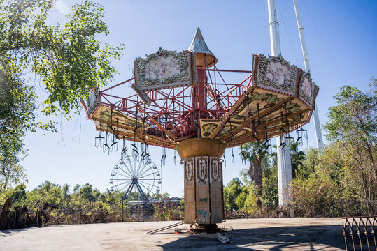 Overgrown roller coaster and decaying rides at abandoned New Orleans amusement park