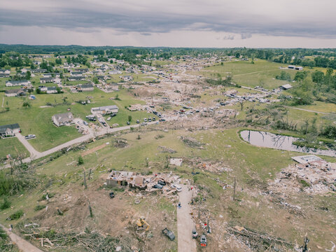Aerial drone view of tornado-damage path through suburban neighbourhood