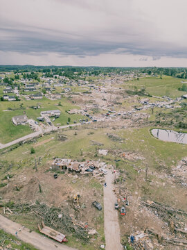 Aerial drone view of tornado-damage path through suburban neighbourhood