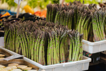 Fresh asparagus bunches at vibrant street market
