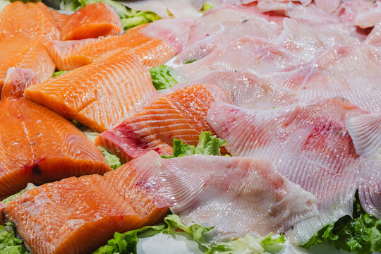 Fresh salmon and white fish fillets on display