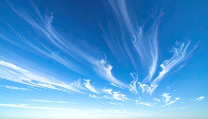 Wispy white cirrus clouds streaking across a vibrant, clear deep blue sky