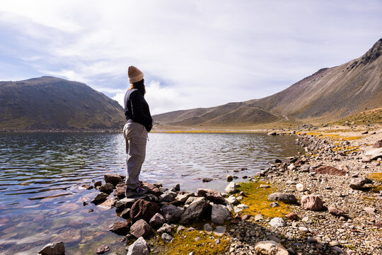 Serene morning hike by a tranquil mountain lagoon