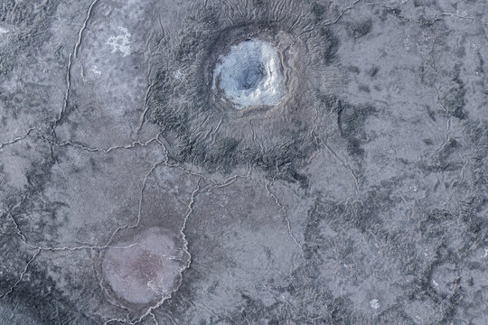 Eroded salt textures on gray earthy surface