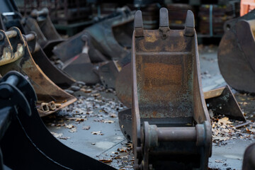 Industrial lineup of used excavator buckets with visible wear patterns and welded edges highlighting durable metal construction and heavy-duty machinery components