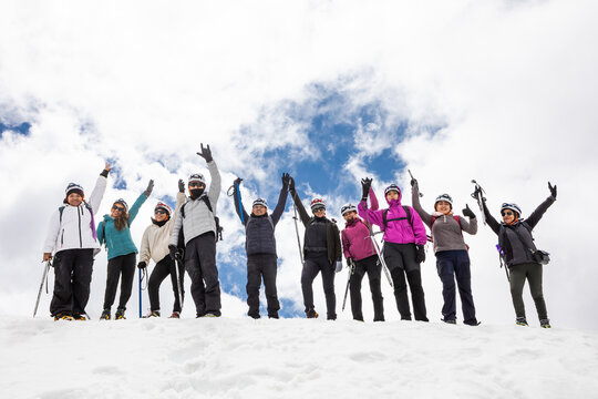 Group of mountaineers celebrating success on snowy peak