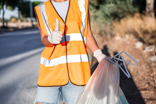 Volunteer cleaning litter on mountain roadside