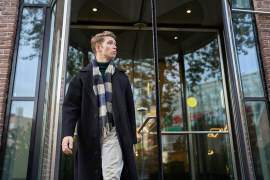 Young man embracing city lifestyle in autumn
