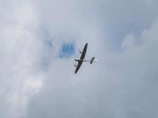 Tactical reconnaissance drone flying against overcast sky during military surveillance operation exercise