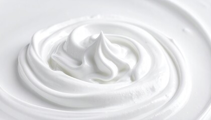 Close Up Of Swirled White Frosting With A Peak In The Center On A White Surface Shot In Studio Lighting