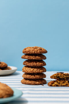 Stack of oatmeal cookies on blue and white background