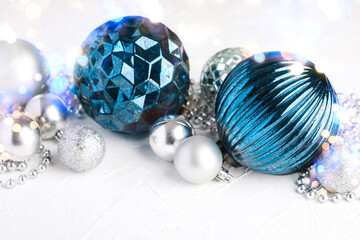 Close-up of various assorted blue and silver Christmas baubles and decorations arranged in a row