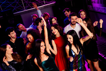 Energetic party night with friends dancing together at a crowded club under neon lights celebrating a festive occasion and pure joy