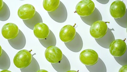 Fresh Green Grapes Arranged in a Repeating Pattern on a White Surface with Natural Sunlight and Shadows