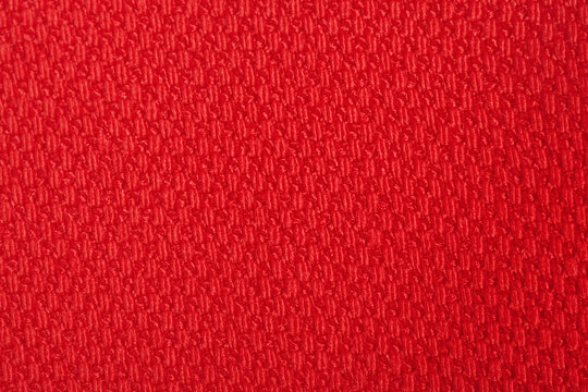 Red fabric macro photo as background.