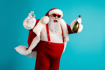 Santa Claus in red suit with a bottle and glass celebrates with friends and family against a bright...