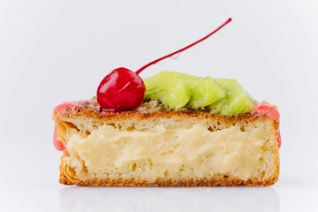 Close-up of a fruit Danish pastry with kiwi, orange slices, and cherry on pink icing