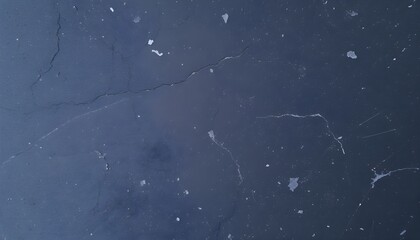 Close-up view of a dark, textured surface with subtle patterns and imperfections.