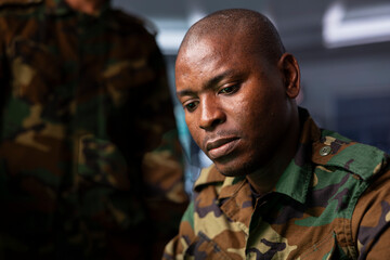 Fototapeta premium Military soldier wearing camo uniform in mission control center, overseeing national safety operations. Infantry unit leader examining data in monitoring room command center