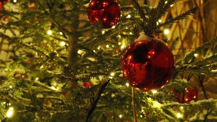 Street decorations before Christmas, multi-colored lights in Christmas balls, Christmas trees under the snow, beautifully lit streets before the New Year. a festively decorated outdoor Christmas tree 
