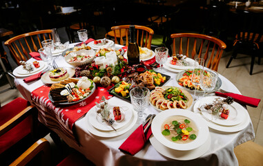 Festive dinner table with assorted holiday dishes and elegant Christmas decorations