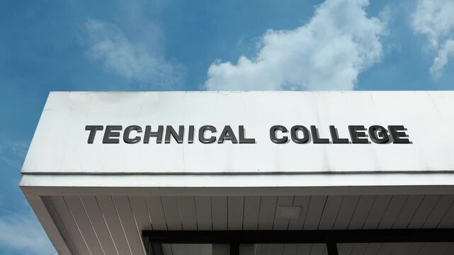 Technical College word sign displayed on an academic or institutional building under a clear blue sky, symbolizing vocational training, applied education, engineering, skilled trades, technology