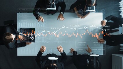 Diverse Group Engaged in Financial Analysis with Data Visualization on Glass Table, Business...