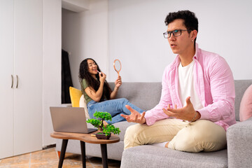 Young man expressing frustration while woman applies makeup