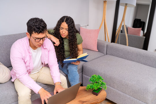 Young couple studying working together at home
