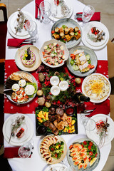 Top view of festive Christmas dinner table with traditional holiday dishes and decorations