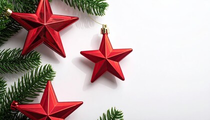 Red Star Ornaments and Green Fir Branches on White Background for Festive Christmas Decoration Arrangement