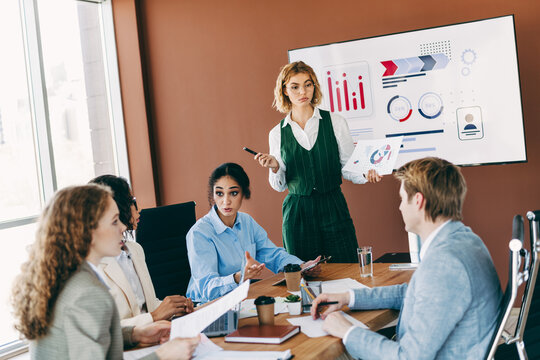 Business professionals collaborating in a team meeting discussing corporate projects and strategies inside a modern office