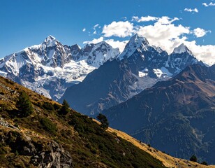 Majestic mountain landscape with snow-capped peaks, clear blue sky, scenic view.