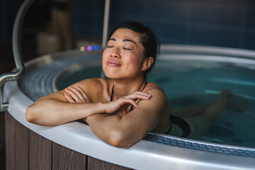 Woman relaxing in hot tub enjoying wellness lifestyle