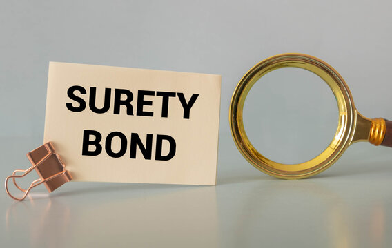 computer mouse and notepad with SURETY BOND text.
