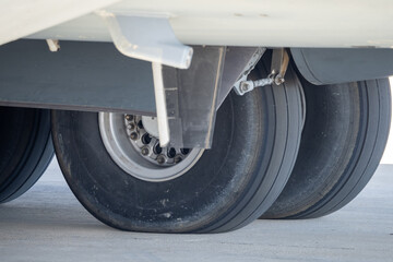 Close-up view of the main landing gear assembly showing dual wheel units with detailed tire texture and hub components on the airframe
