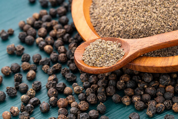 Flavored black pepper powder in a spoon and bowl - Piper nigrum