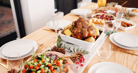 Food, thanksgiving and turkey dinner at house, holiday meal or feast with vegetable dish or salad. Table setting, tradition and cuisine with roast supper for celebration, event and festive decor