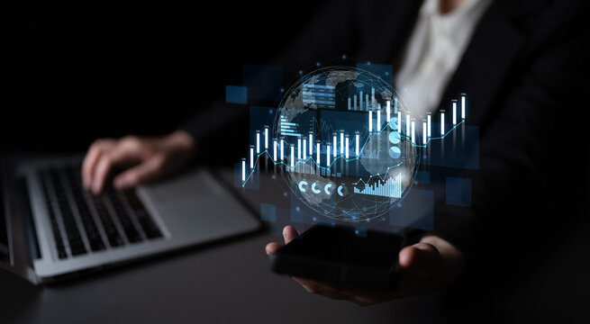 A business professional holds a smartphone displaying a digital globe and data graphs in a dark environment, highlighting modern technology role in data analysis and decision-making. Scalp