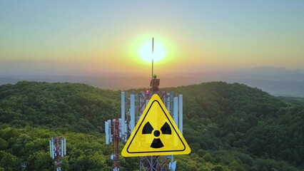  Electromagnetic wave radiation sign on a radio tower, while engineer working 