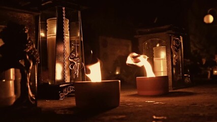 Burning candles and lanterns at night, warm light and flame close-up for All Saints’ Day in Poland