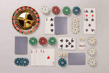Poker chips and playing cards on color background, top view. Casino card game